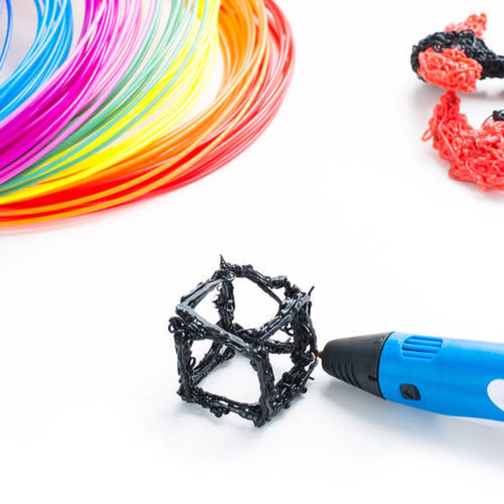 Colorful rainbow plastic filaments with for 3D pen laying on white. New toy for child. 3d paintings and figures with their own hands.